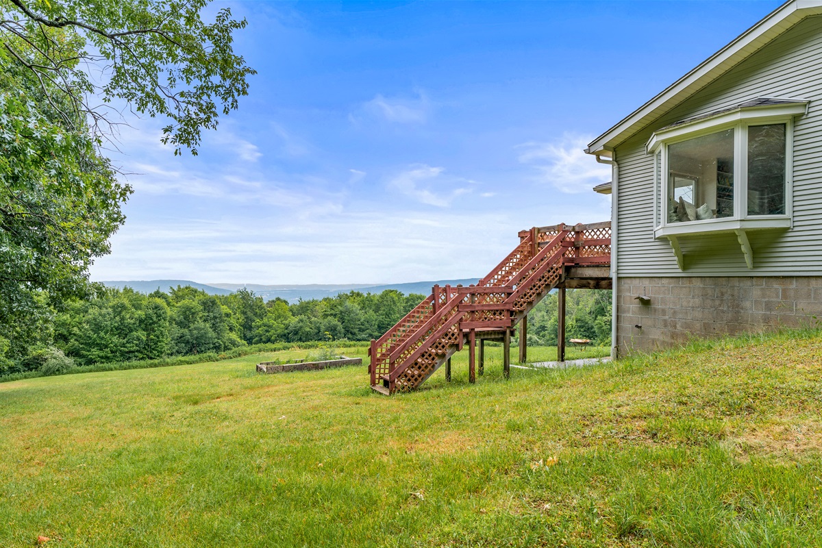 Step out onto a multi-tiered deck and soak in panoramic views of rolling hills and endless greenery