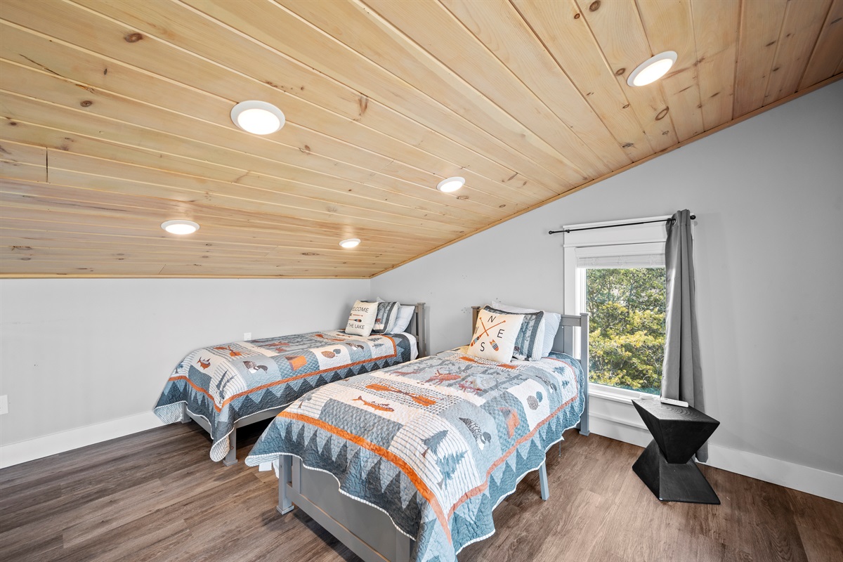 Loft sleeping area with twin beds—great for kids or additional guests, offering comfort without sacrificing space elsewhere.
