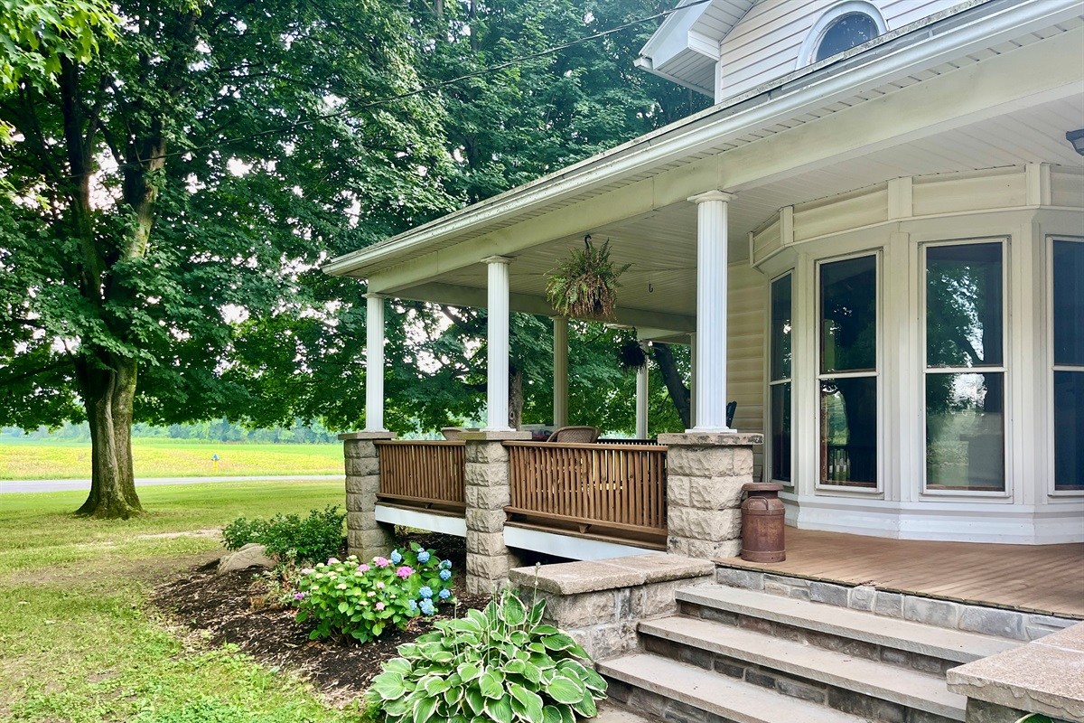 Large Front Porch with Rocking Chairs and Table