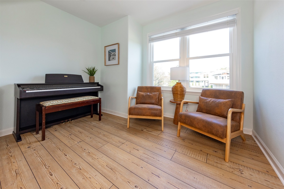 A digital piano sits off to the side of the living room area