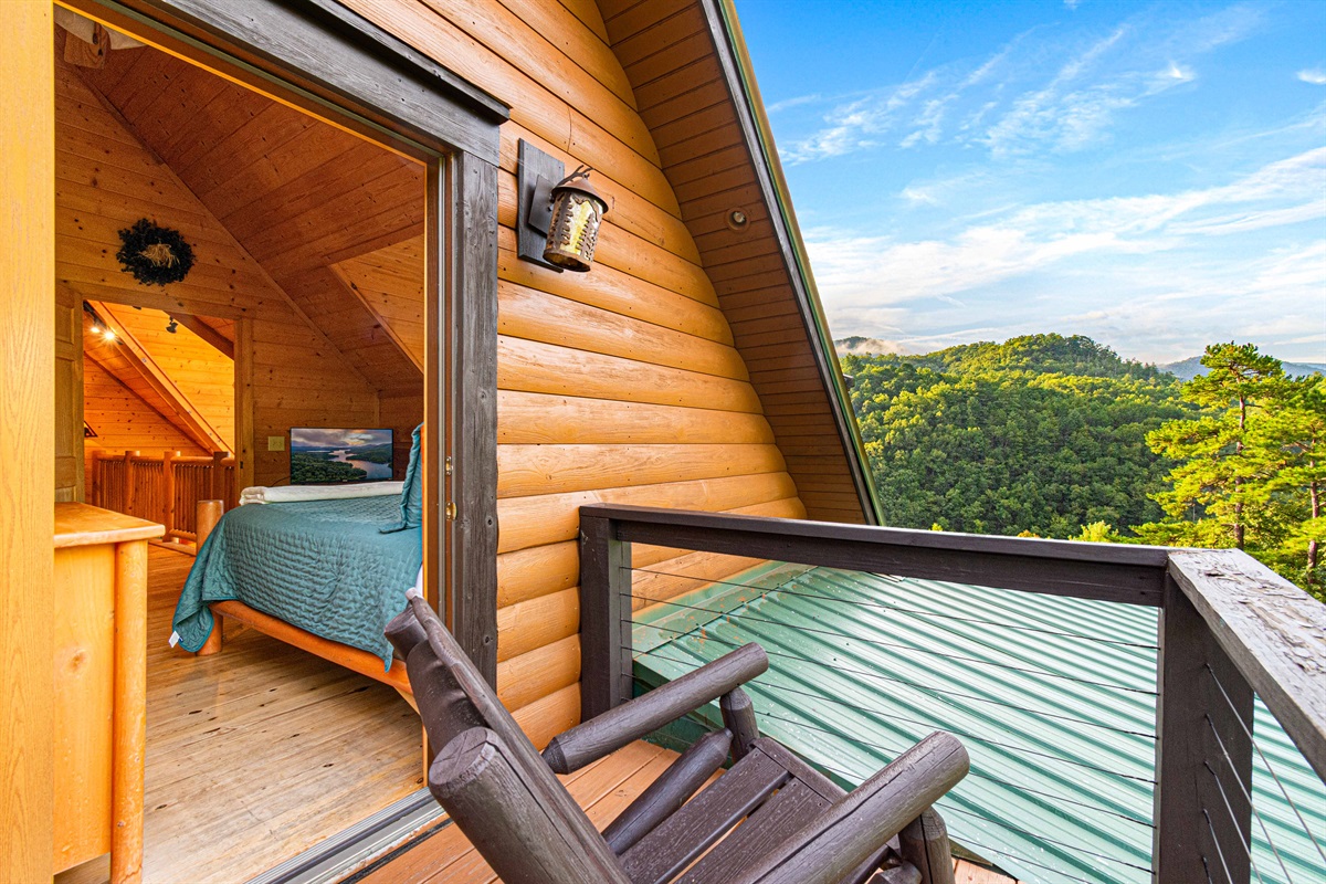 Upstairs Bedroom 1: Wake up to stunning mountain views from your private balcony retreat!