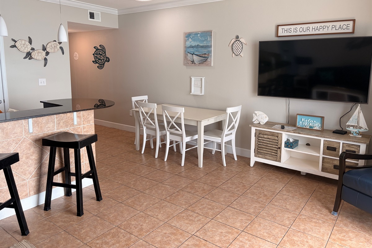 Spacious Dinning table for the whole family, along with kitchen bar stools. Next to the TV