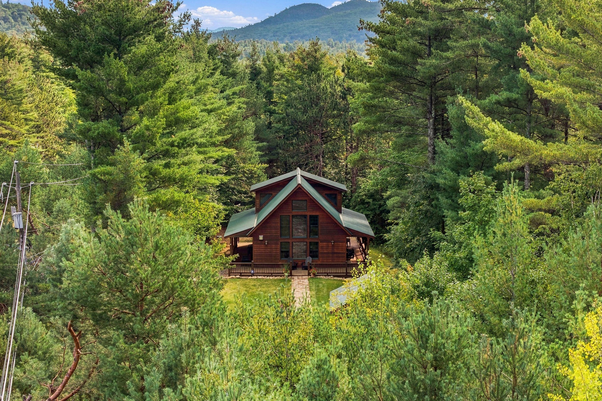 Escape to a private Adirondack lodge nestled among the trees and breathtaking views of Whiteface Mountain.