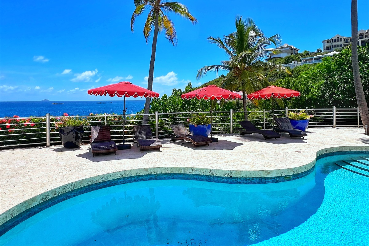 Swim under sunny skies in the villa&rsquo;s private pool area.