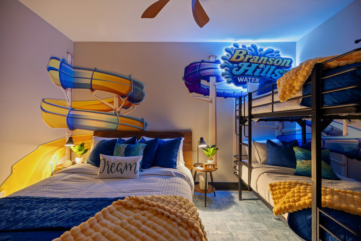A 'Dream' pillow and teal accents by the glowing slide mural.