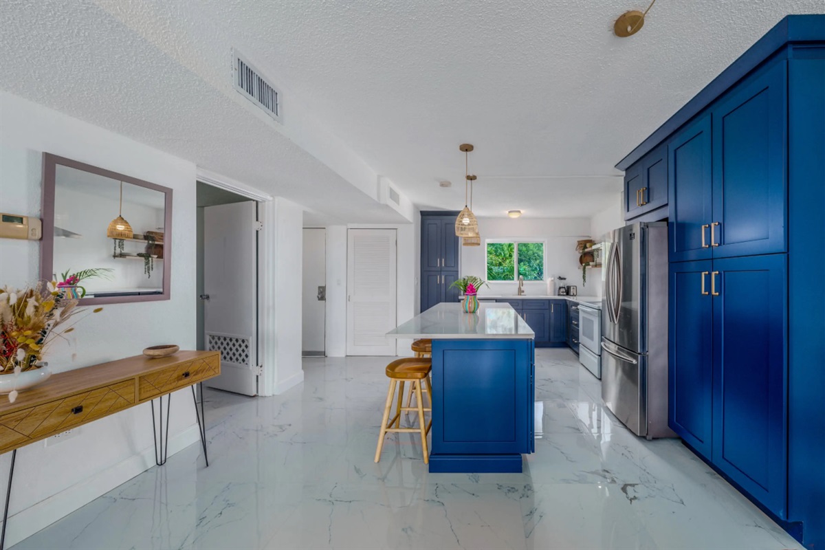 Welcoming entryway that opens into a bright, fully equipped kitchen designed for comfort and convenience.