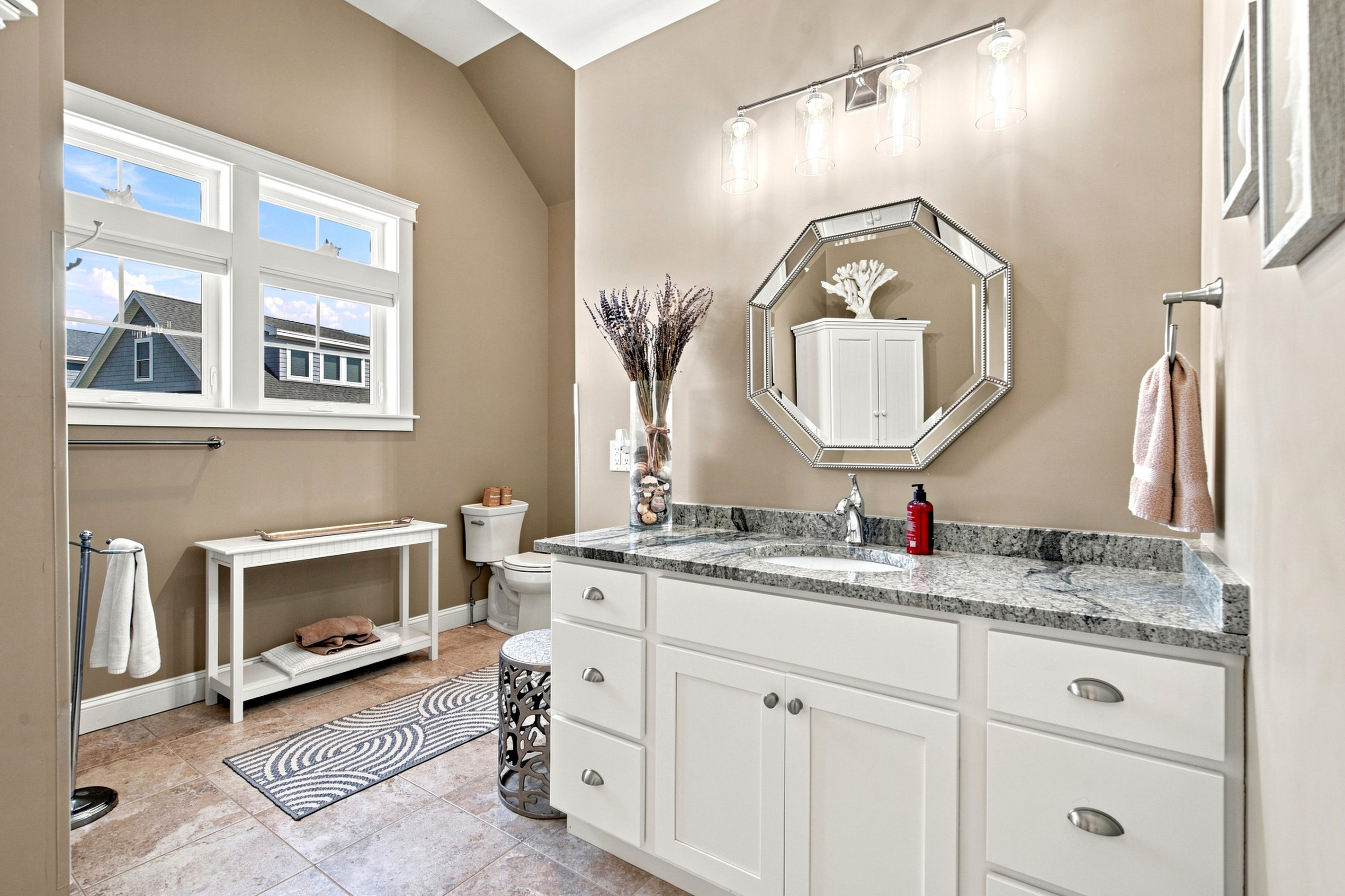 A spacious bathroom vanity provides plenty of counter space and storage for getting ready with ease.