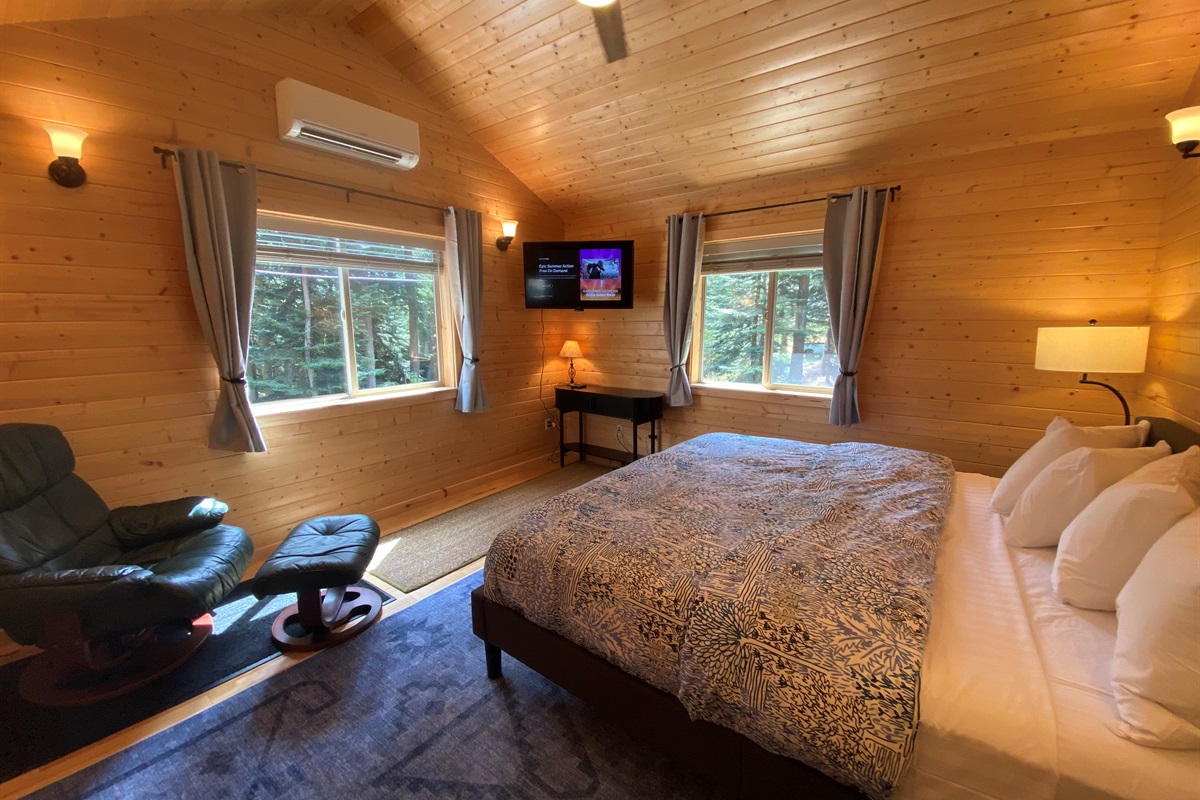 Beautiful pine paneling inside and forest views outside are enjoyed in this retreat bedroom.