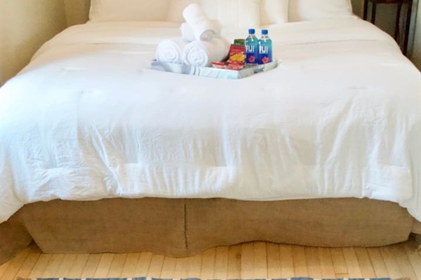 Comfortable King bedroom with plush bedding designed for a restful night's sleep.