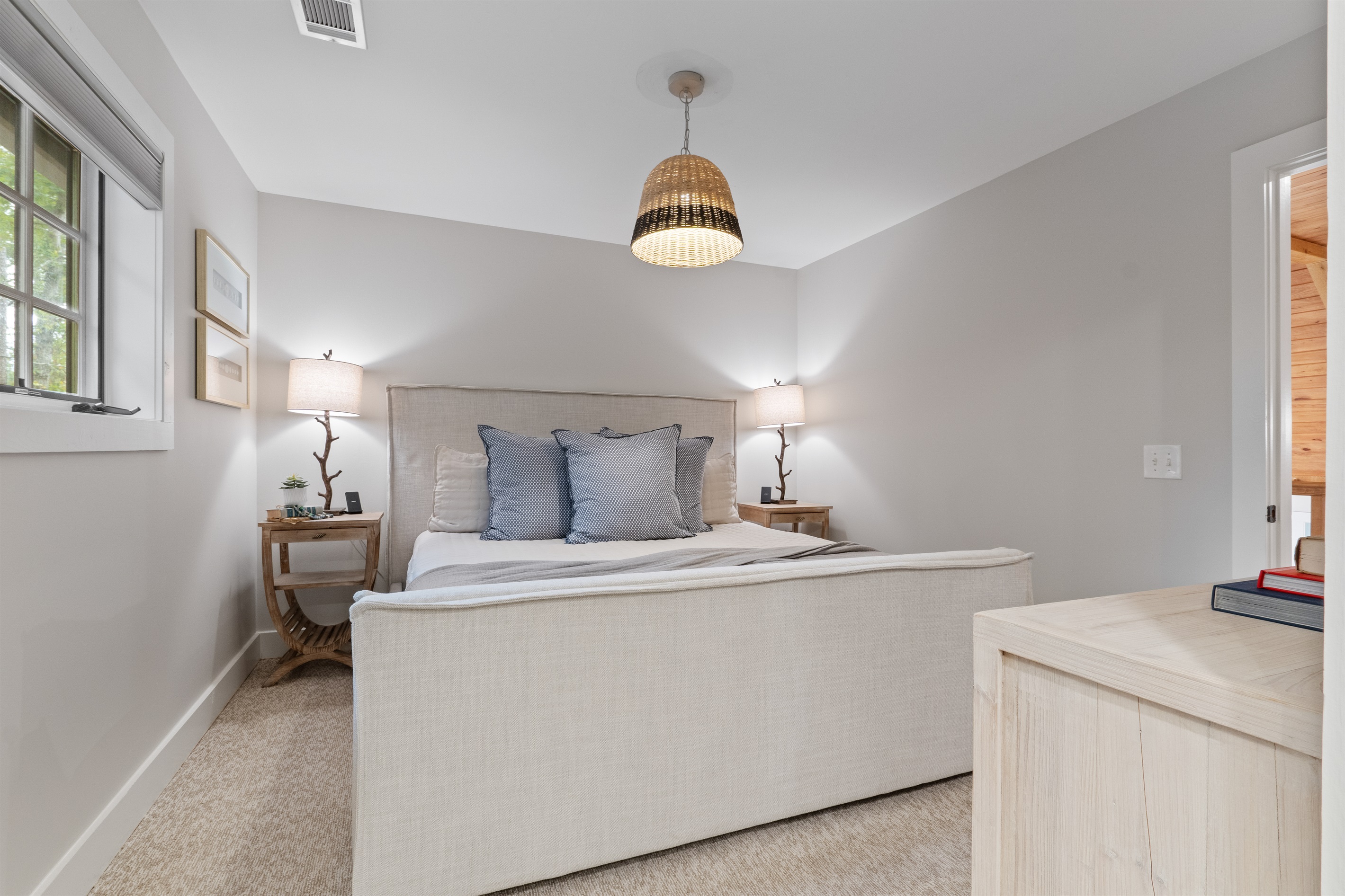 The third bedroom features a large king bed, offering plenty of space and comfort for a restful night’s sleep.