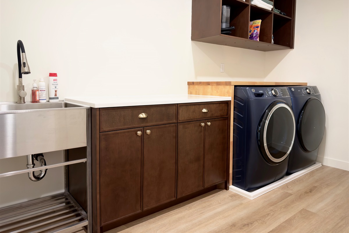 Modern laundry room with shelving, supplies, and folding space to make vacation chores a breeze.