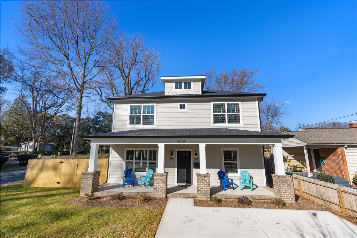 The large home has a beautiful entryway, with seating for enjoying Charlotte's gorgeous weather.