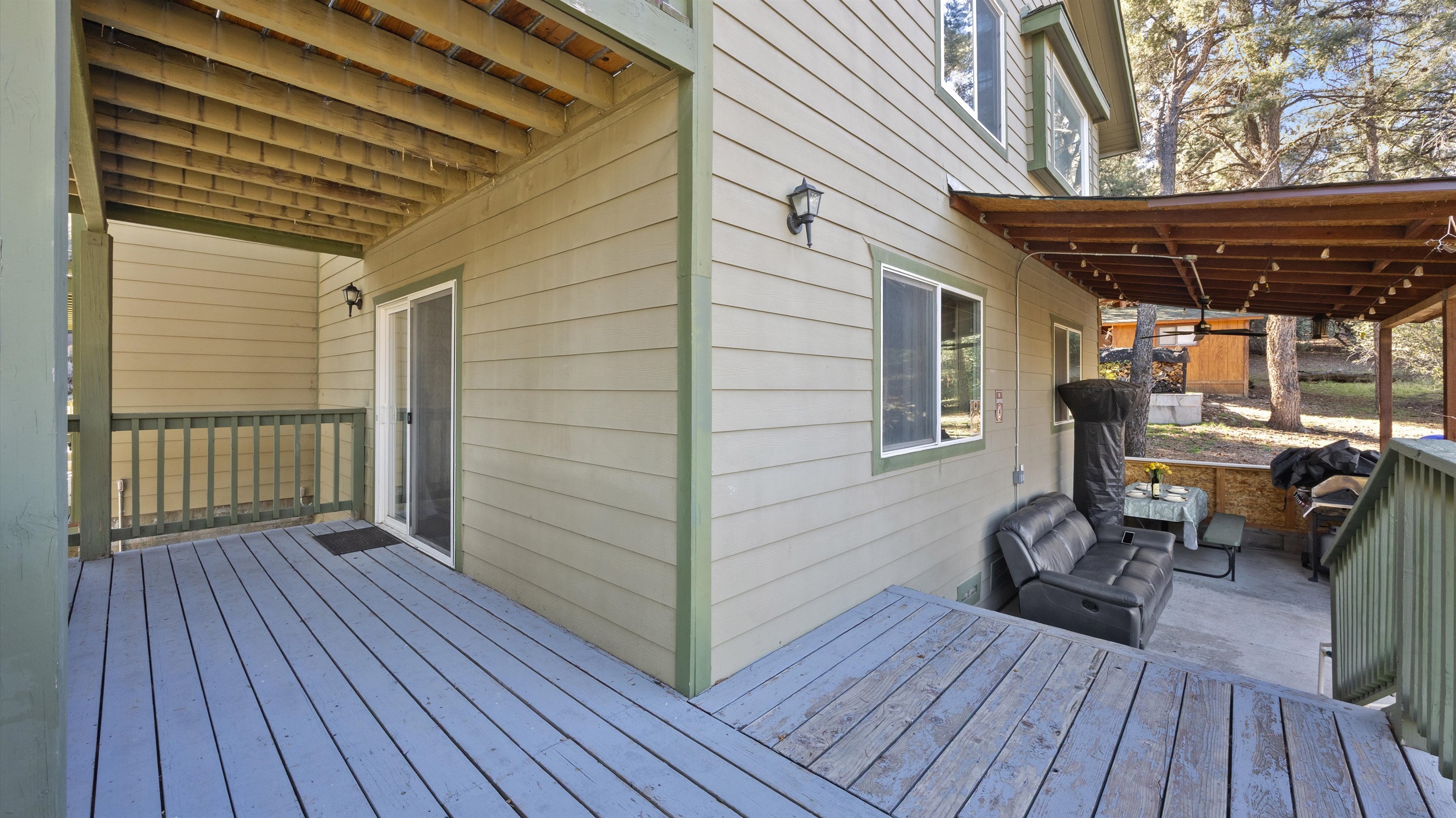 The balcony opens to a serene back patio, surrounded by peaceful nature and fresh mountain air.