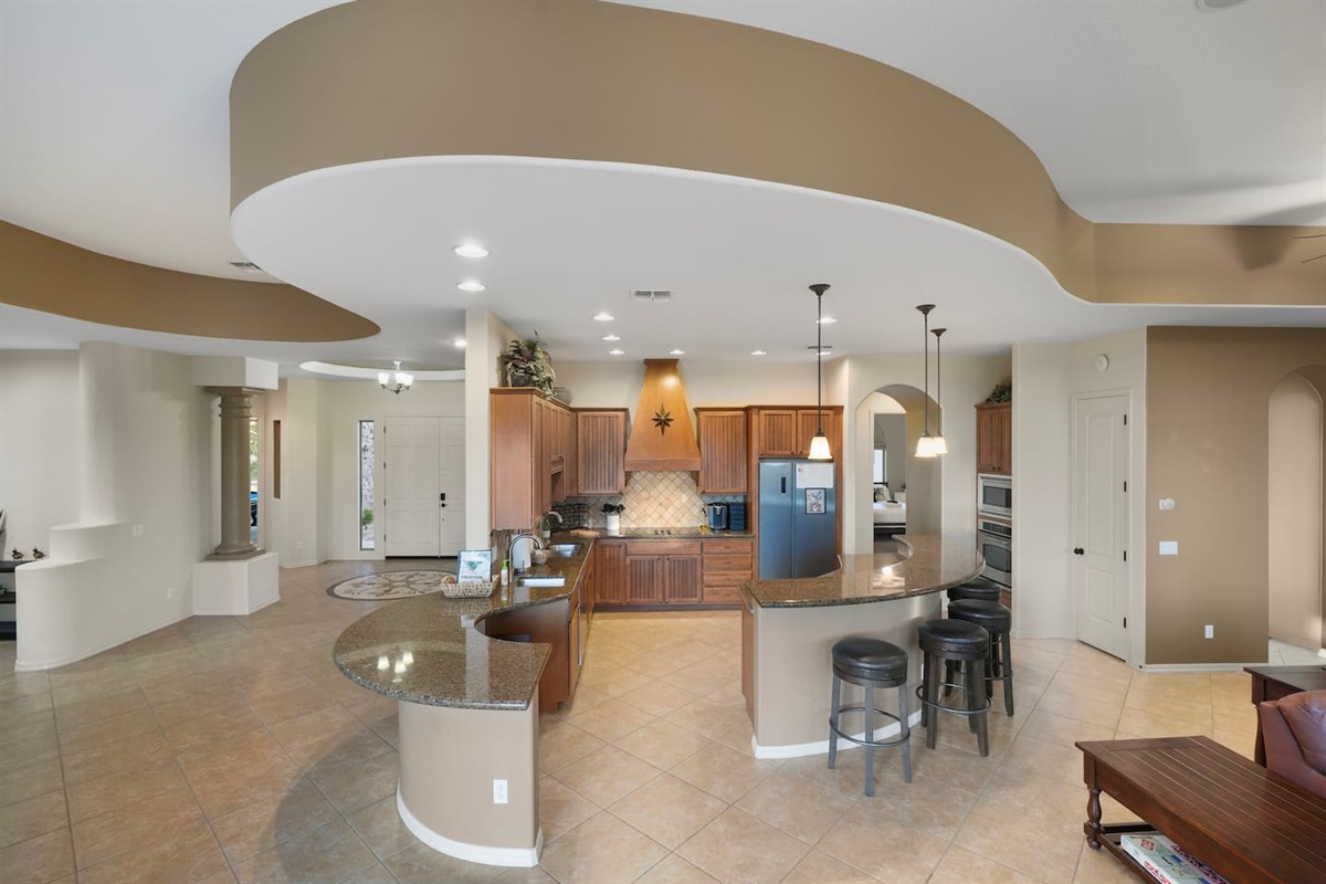 Open-concept kitchen with ample prep space and seating for casual dining.