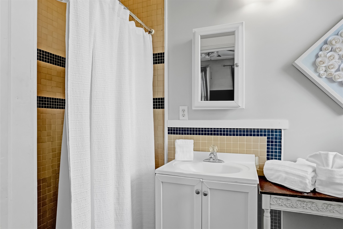 Refresh and unwind in the roomy walk-in shower with elegant tile accents.