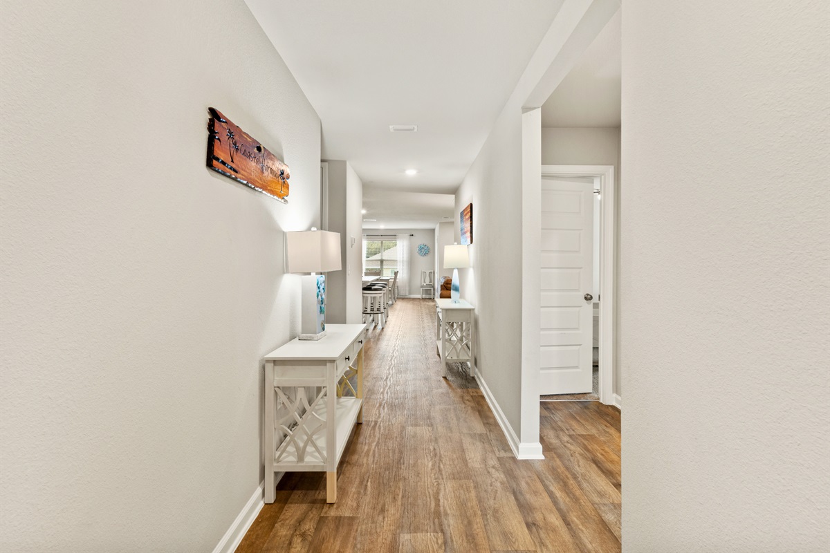 Inviting hallway that flows easily through this coastal home, connecting bedrooms, living, and dining areas.