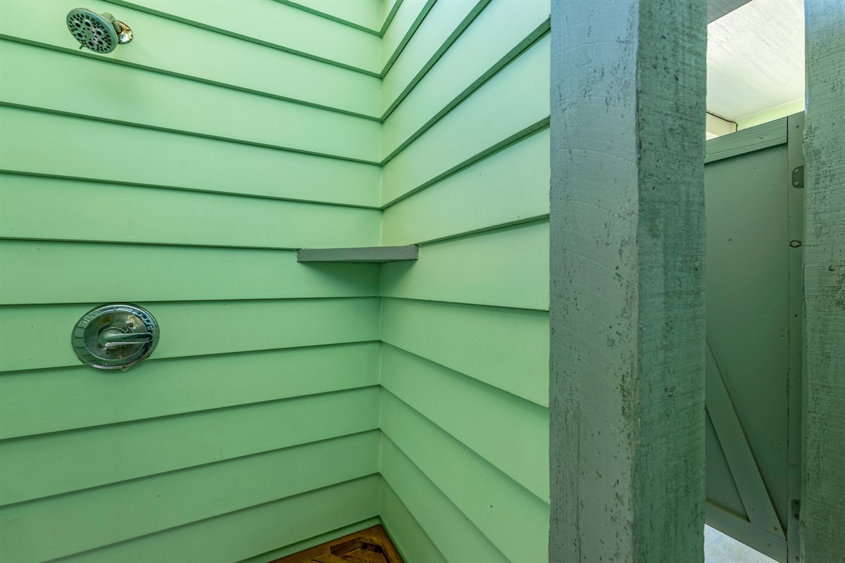 Crystal Paradise Outdoor Shower: Convenient outdoor shower perfect for rinsing off after a day at the beach while enjoying the fresh coastal breeze.