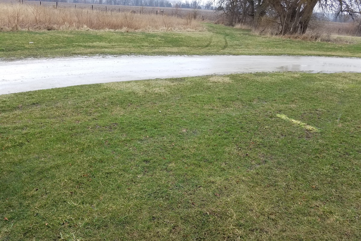 The grass parking area has room for two cars or for sitting outdoors to enjoy the sunsets.