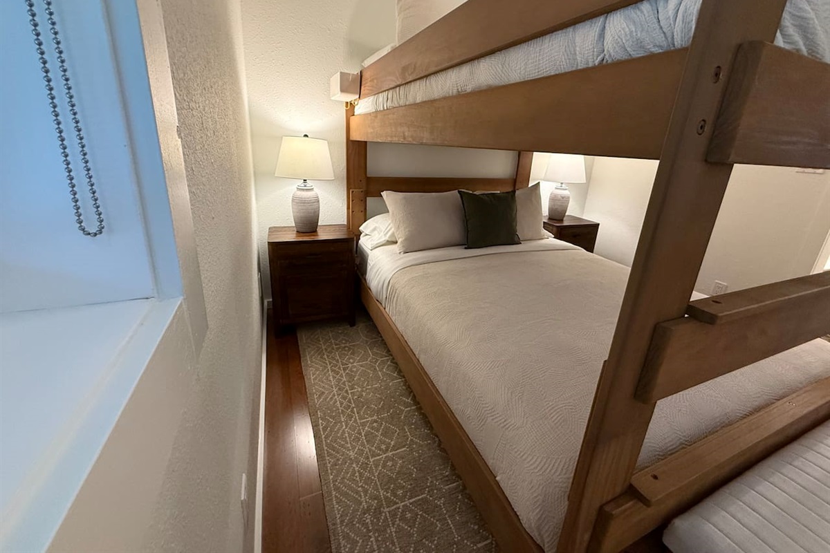 Nightstands with a lamp and electrical outlets and USB outlets on either side of the bed. 
