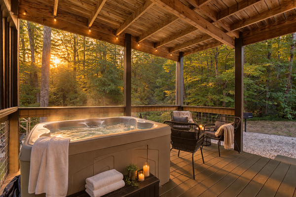 Hot tub at golden hour, wooded privacy, no neighbors in view. Couples retreat near Gatlinburg and Pigeon Forge.
