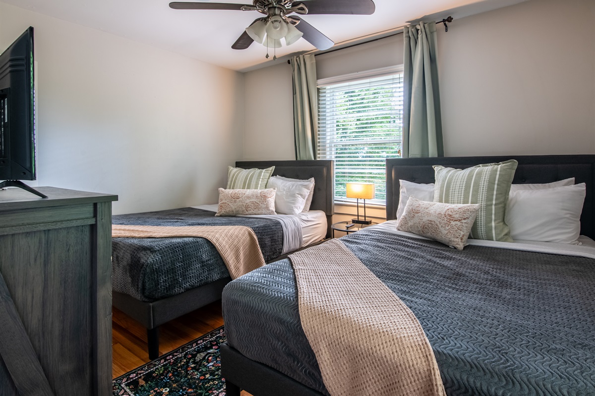 Another bedroom view featuring soft linens, natural light, and relaxing tones.