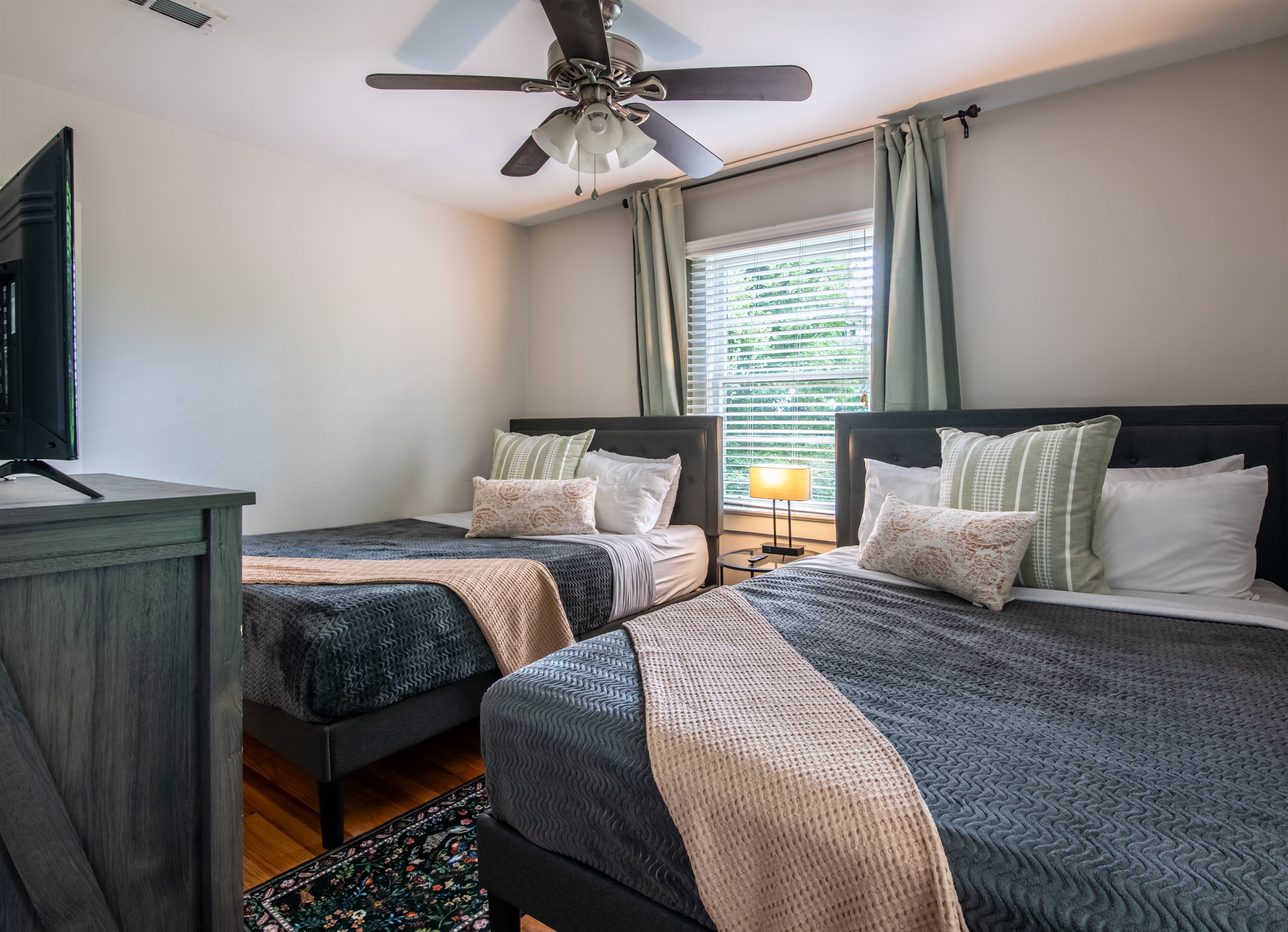 Another bedroom view featuring soft linens, natural light, and relaxing tones.