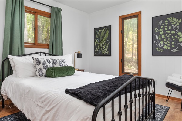 Unwind in this serene Queen bedroom with its own half bath—perfect for a peaceful night's rest.