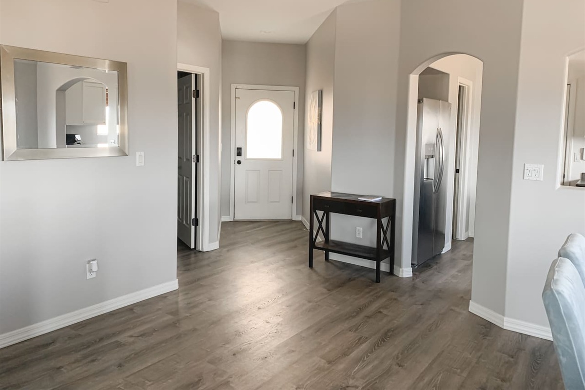 View from living room toward the welcoming front entry and open hallway