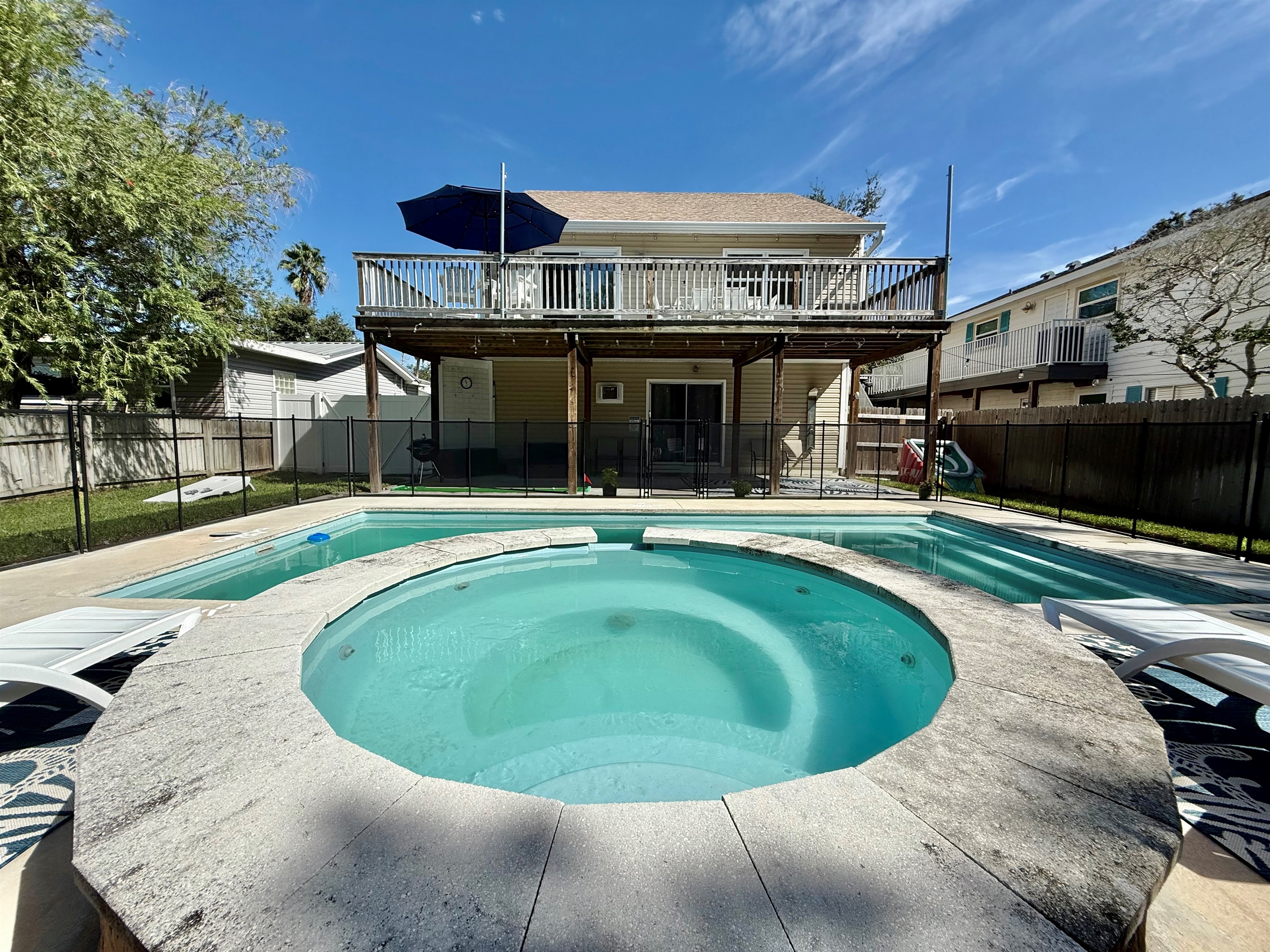 Relax in the elevated spa while overlooking the pool and backyard.