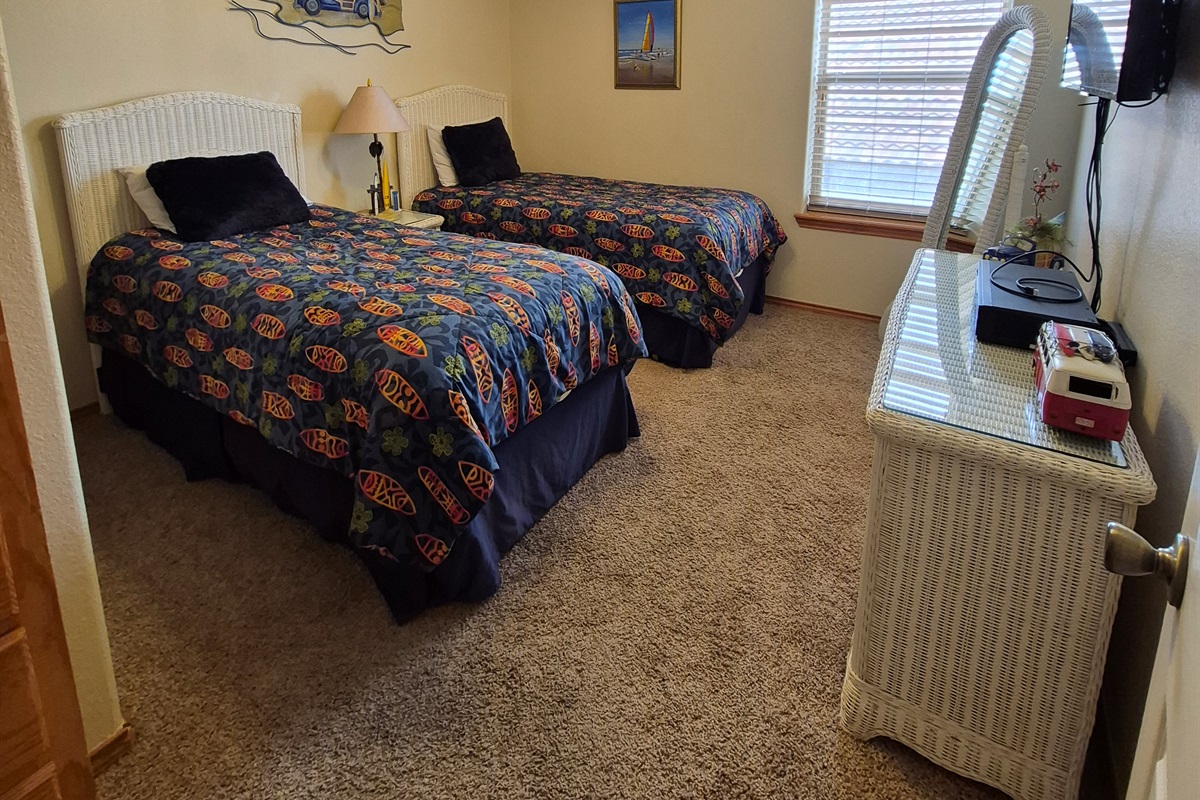 Enjoy the surfing vibes in this 3rd level double twin guest bedroom. (TV, VCR/DVD player, HDMI connectivity)