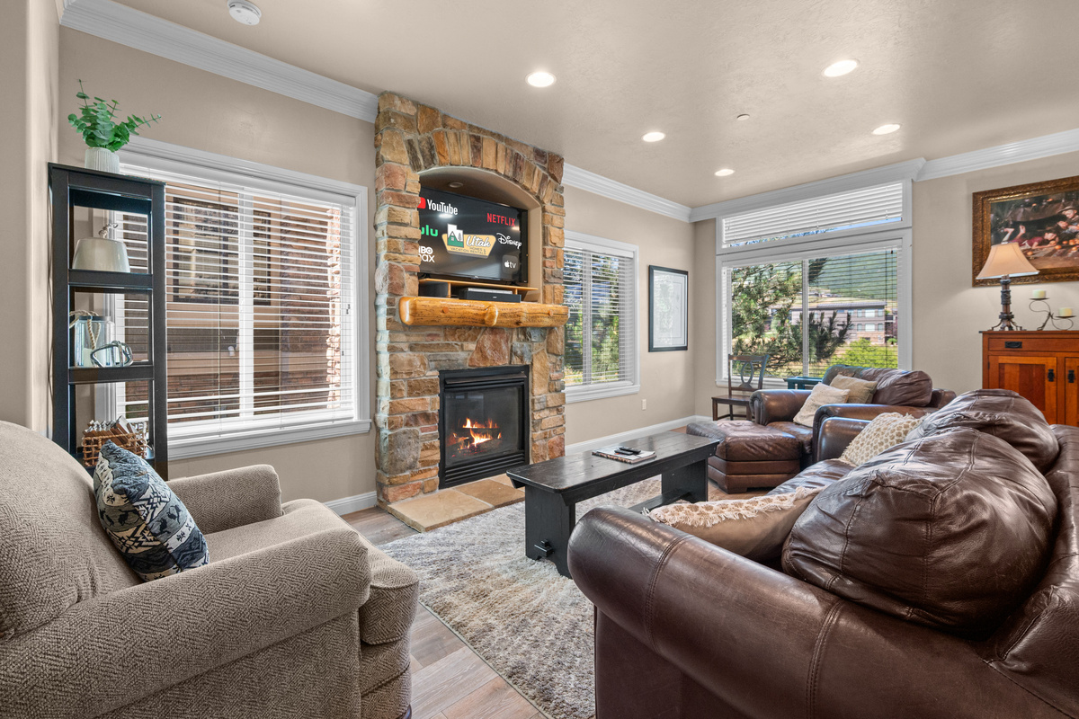 Relax by the cozy gas fireplace while enjoying abundant natural light and mountain-inspired décor.