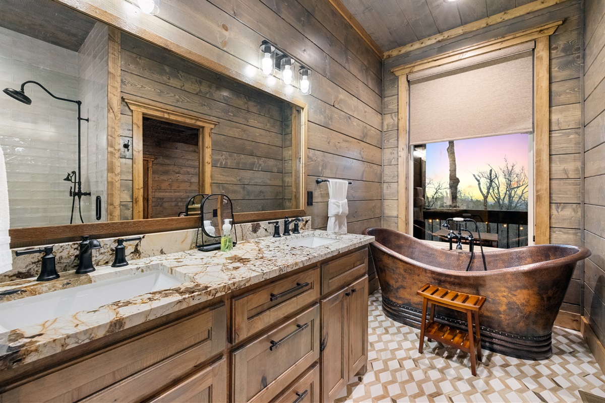 Luxury bathroom featuring a stunning copper soaking tub and elegant finishes