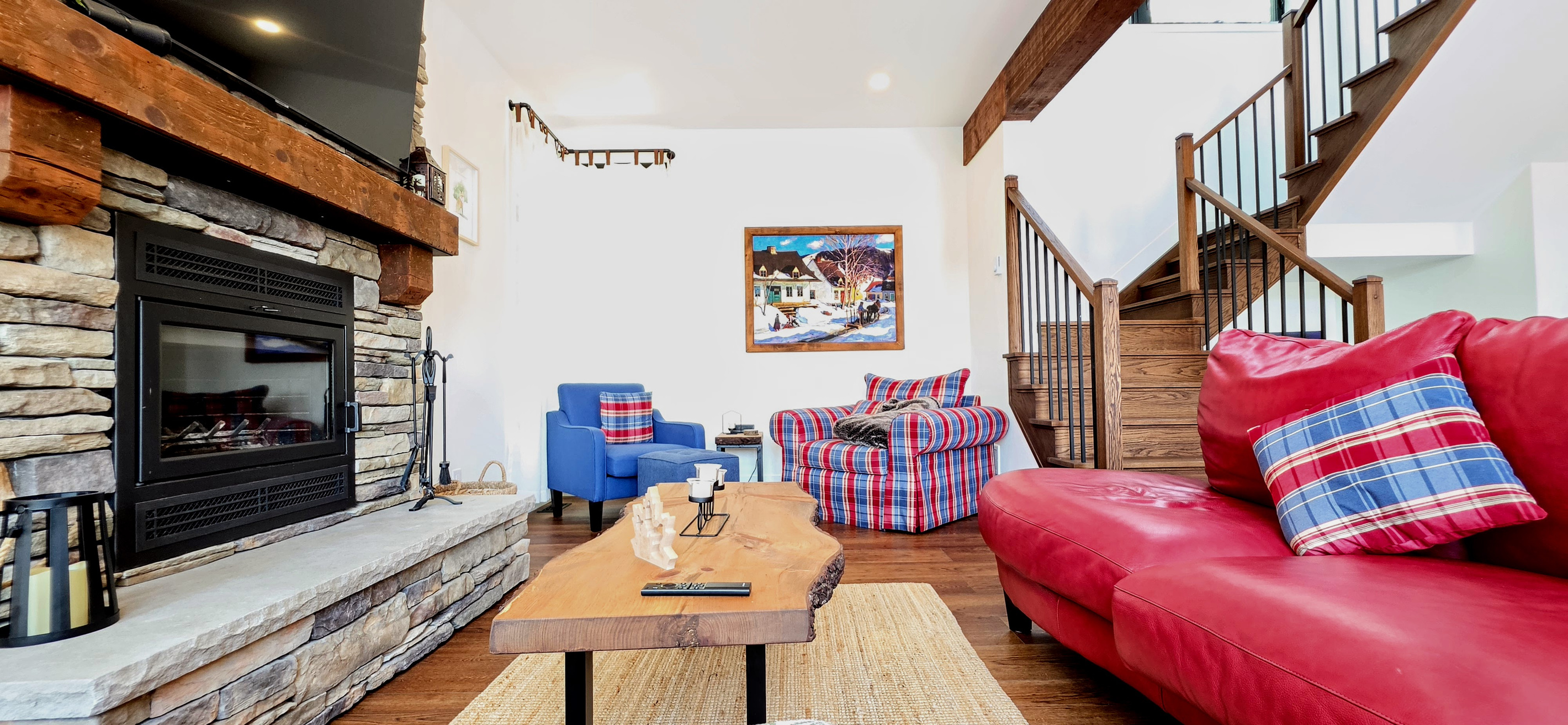 Living room seating showing fireplace and large TV above