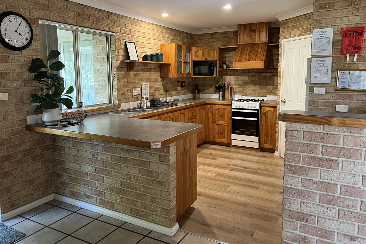 Large Country style kitchen with full size fridge and gas cooking