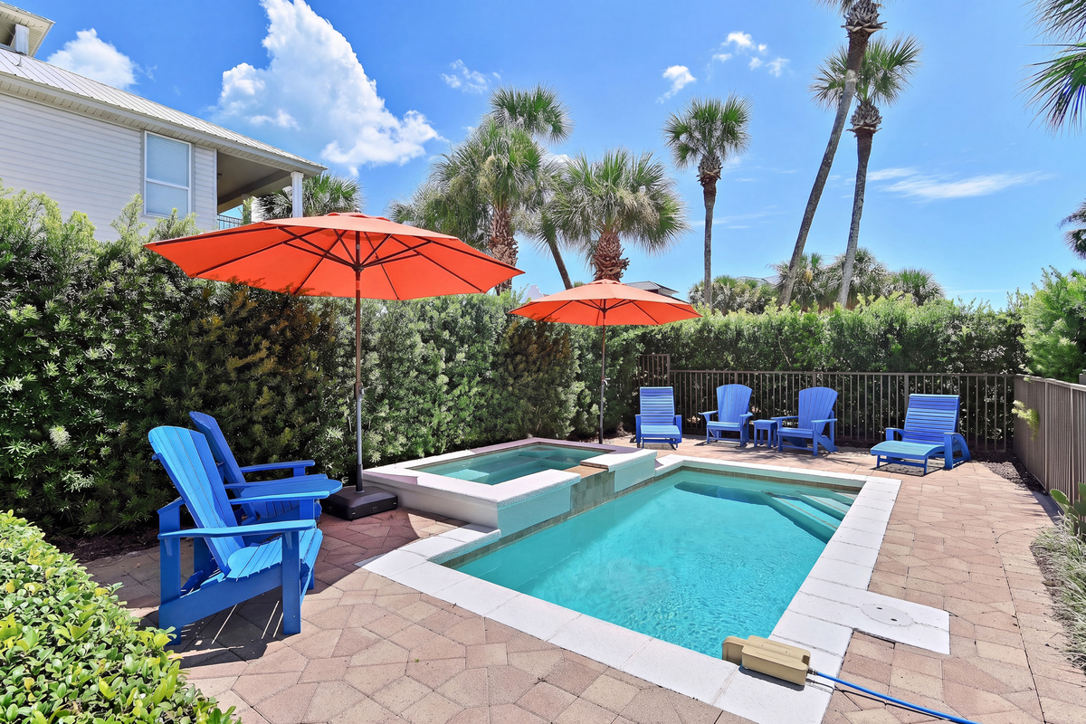Enjoy sunny afternoons by the private pool and spa, surrounded by tropical palms and colorful coastal touches. The perfect place to relax, unwind, and make unforgettable 30A vacation memories.