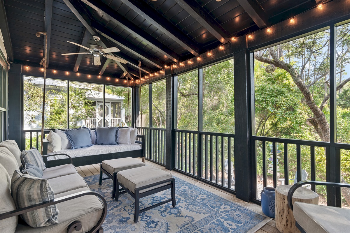 Screened Porch
A guest favorite, the screened-in porch features a cozy bed swing, sofa, rocker, and footstools. Two ceiling fans and string lights create the perfect setting for morning coffee, family time, or evening wine with peaceful wooded views.
