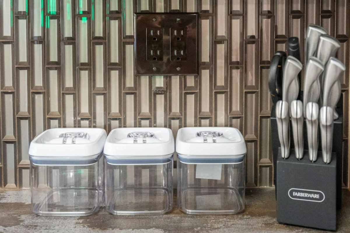 Thoughtful kitchen essentials, from airtight containers to a full knife set, mean this space is ready for real cooking, not just reheating.