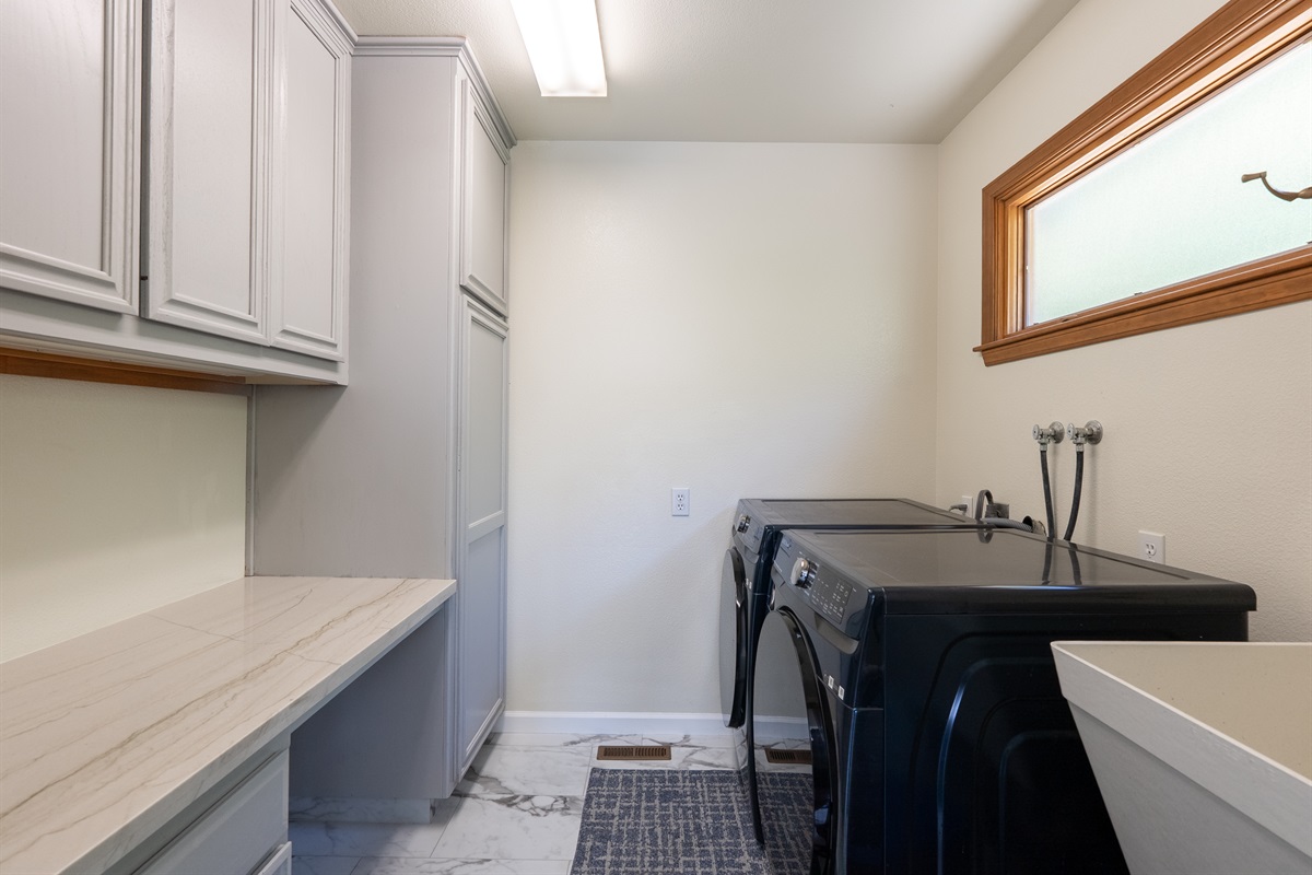Efficient laundry area with high-end appliances.
