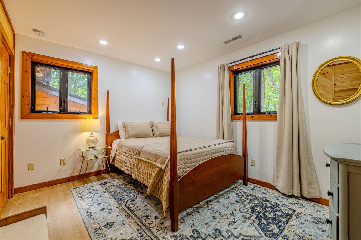 Bathed in natural light, this beautifully styled queen bedroom offers a bright and tranquil retreat on the upper level.