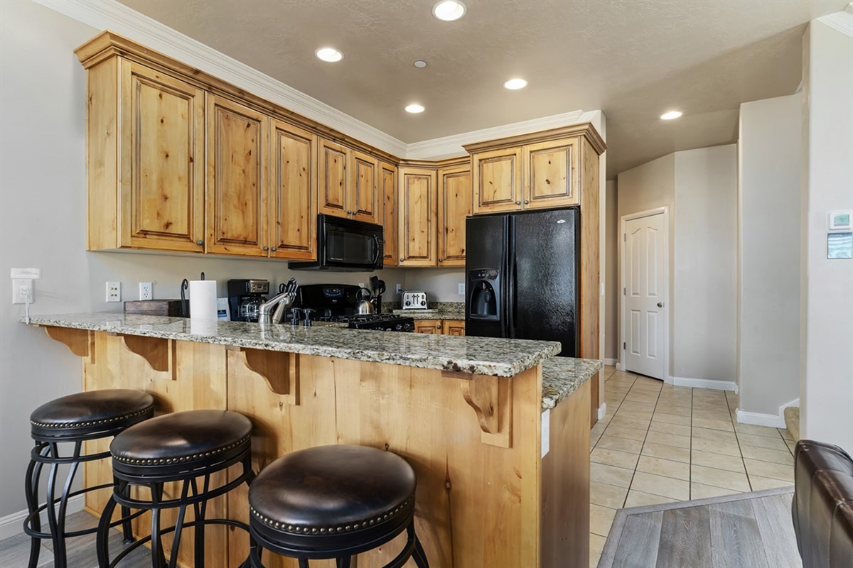 Open kitchen with bar seating—perfect for casual meals, coffee, or conversation.