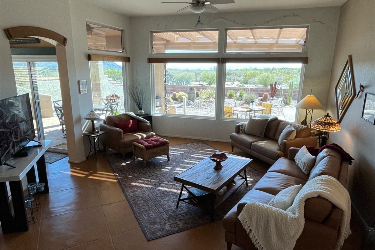 Spacious, bright and sunny living room area with mountain views.