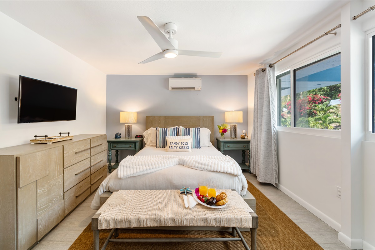 Primary bedroom with Queen bed, ceiling fan and large windows to let in that Caribbean sunshine