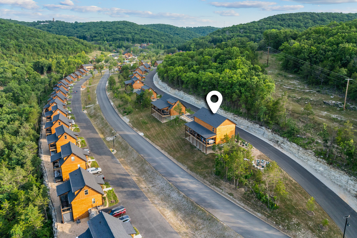 The community-road aerial with a location pin marking Lone Star Lodge among the Tall Timbers cabins.