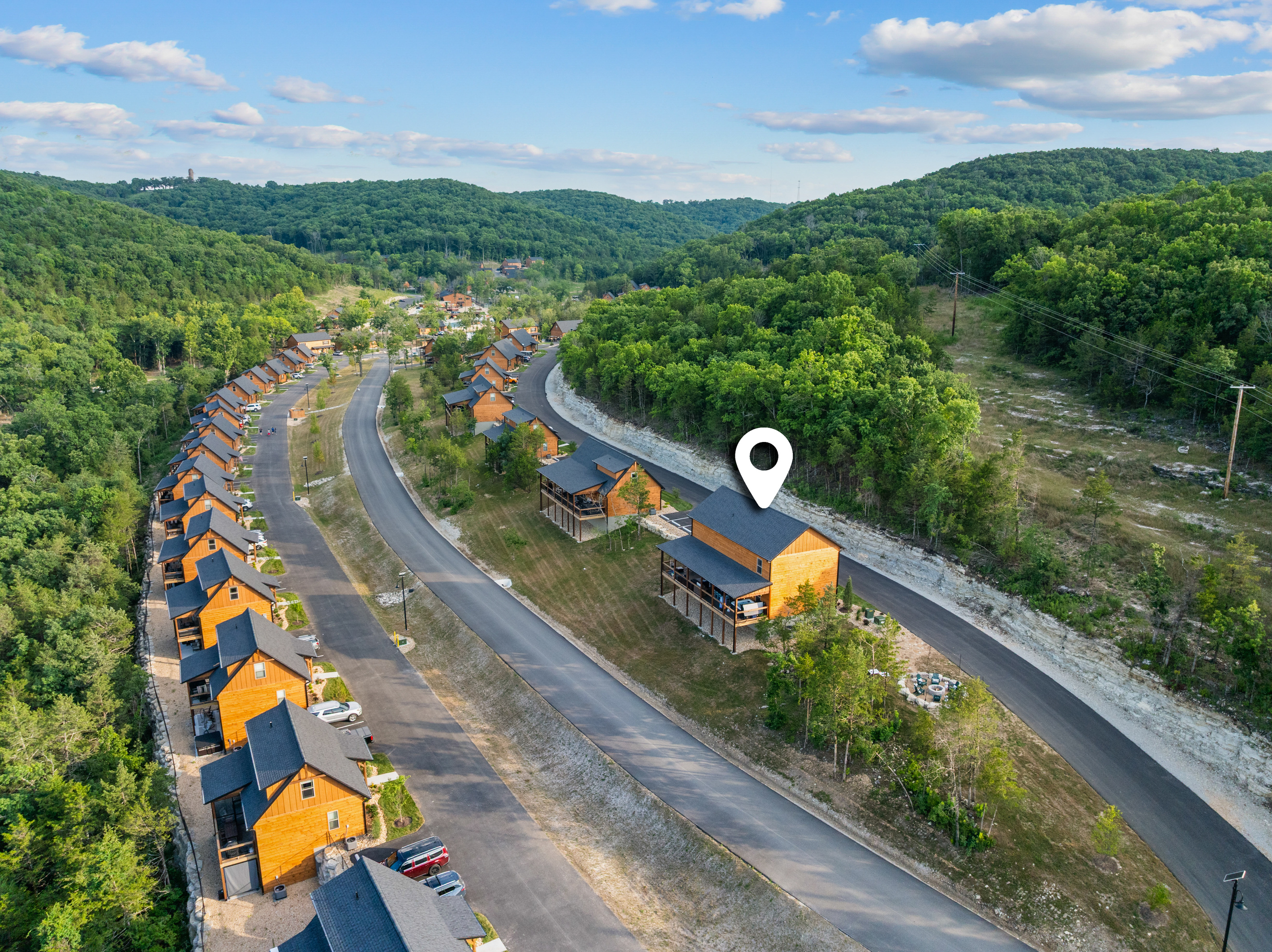 The community-road aerial with a location pin marking Lone Star Lodge among the Tall Timbers cabins.