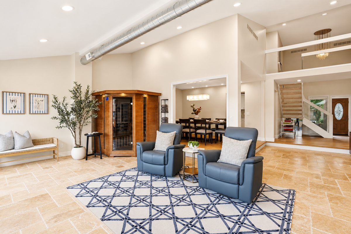 Relax in this spacious indoor pool lounge featuring a private sauna, soaring ceilings, and comfortable seating areas. The open-concept design creates the perfect space to unwind, gather with family and friends, or enjoy a luxury resort-style experience
