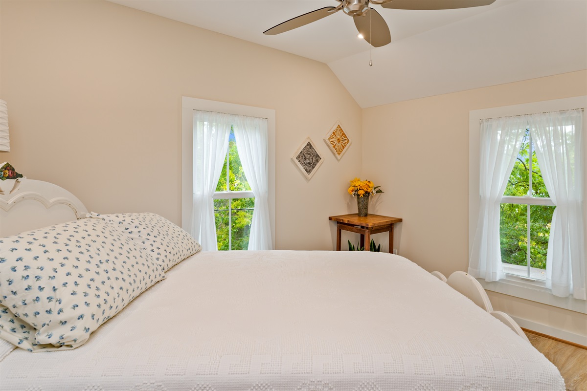 Inviting bedroom with serene views, soft natural light, and a plush white comforter for restful nights. Bedroom #2 double