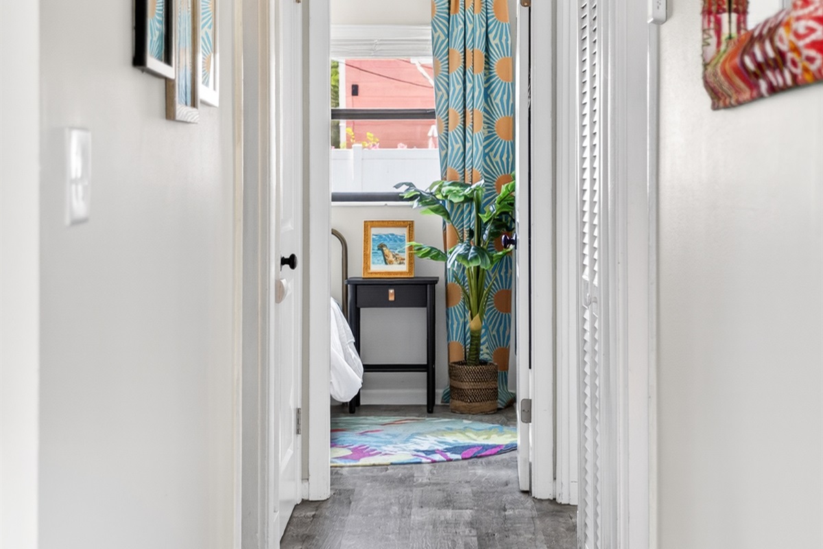 Back inside the hallway leads from the living room to all 3 bedrooms.