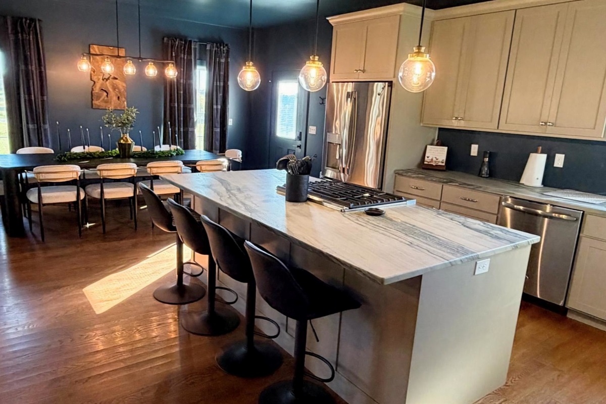 A chef-inspired kitchen designed for connection — with stone countertops, artisan lighting, and premium appliances ideal for tastings, chef dinners, and effortless entertaining.