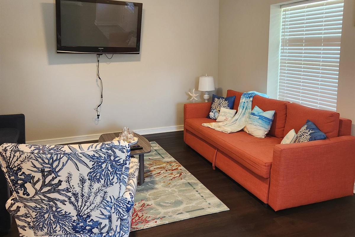 Relax and recharge in this cozy coastal-inspired living space, where bold colors meet beachy charm!