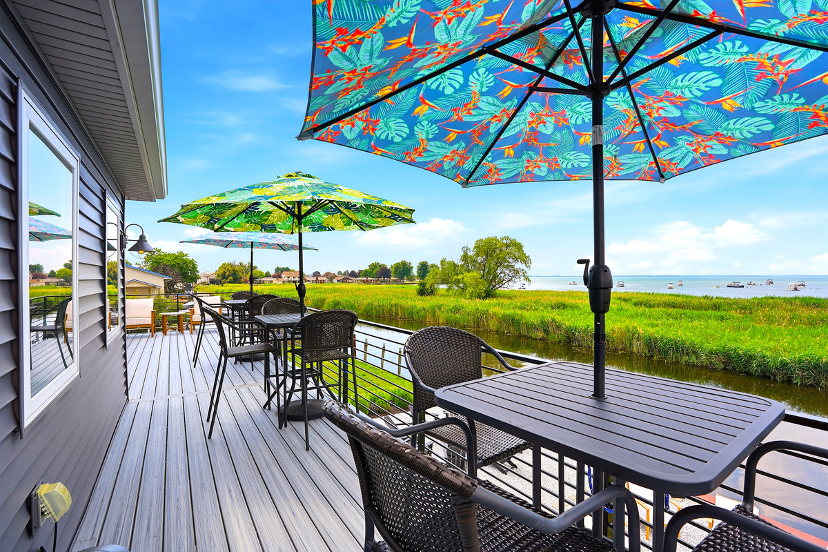 From sunrise coffee to sunset conversations, this spacious balcony offers multiple seating areas so everyone can enjoy the spectacular waterfront scenery.